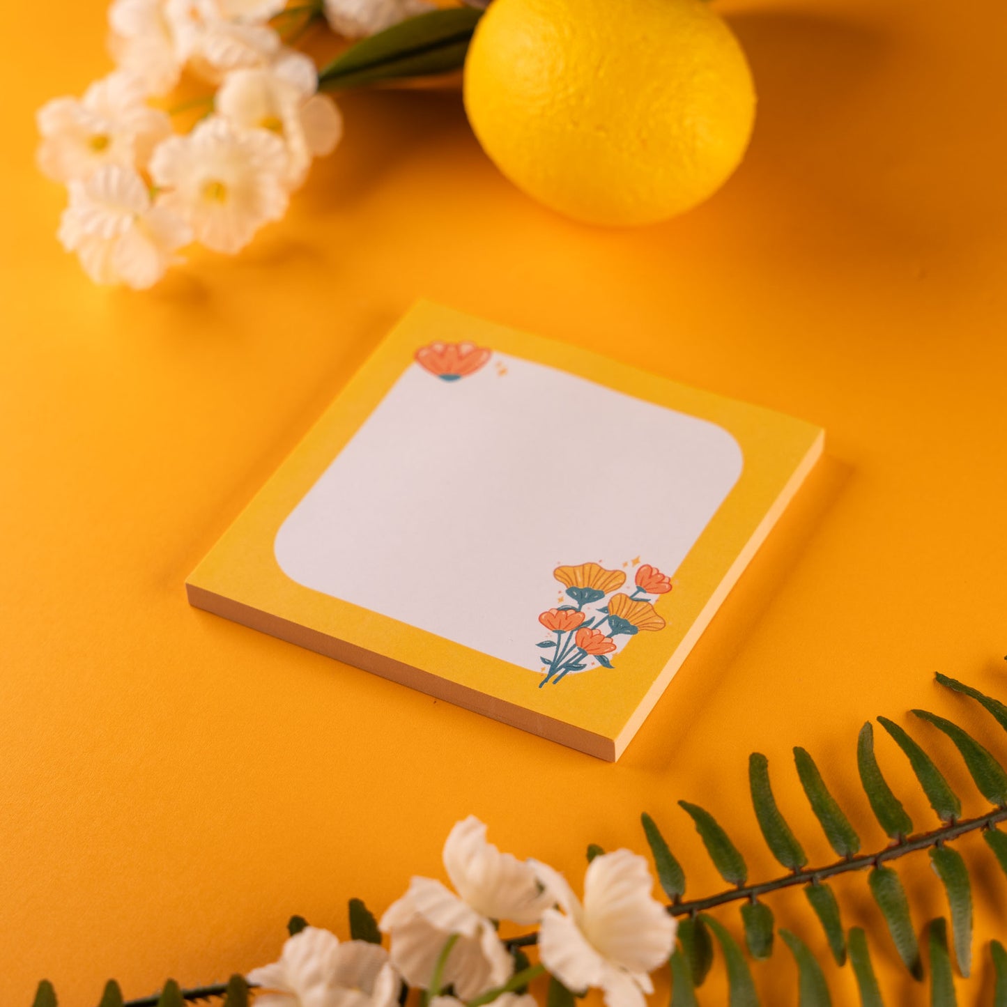 Yellow Border Flower Bouquet Sticky Note Pad with a flower bouquet design in the bottom right corner, displayed on a vibrant yellow background with a lemon, white flowers, and green fern leaves surrounding it.